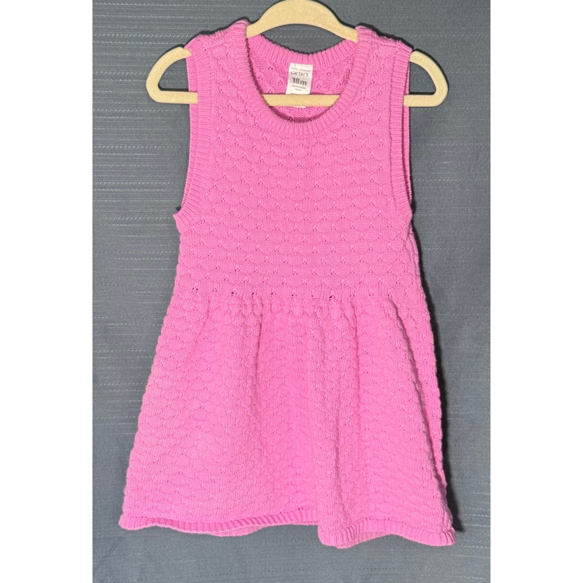 Front view of Carter's pink textured knit sweater dress for baby girls, size 18 months, with round neckline and gathered skirt.