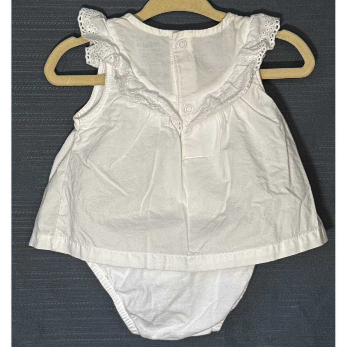Back view of Carter's Child of Mine white baby girls' bodysuit dress, size 0–3 months, showing eyelet ruffles, back snaps, and dress overlay.