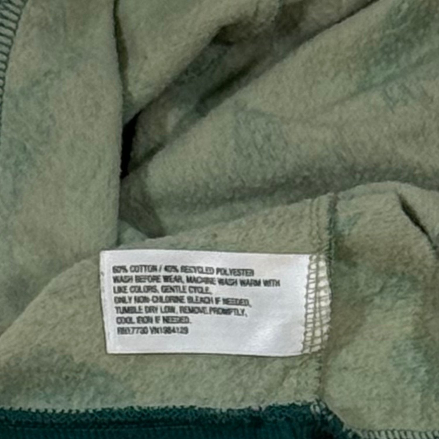 Cat & Jack baby boy clothing material tag showing 60% cotton and 40% recycled polyester