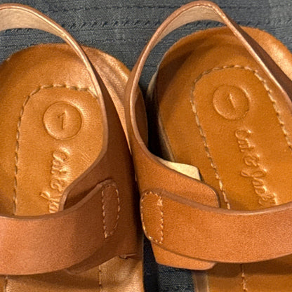 Close-up of Cat & Jack girls’ tan-brown sandals showing surface details and wear.