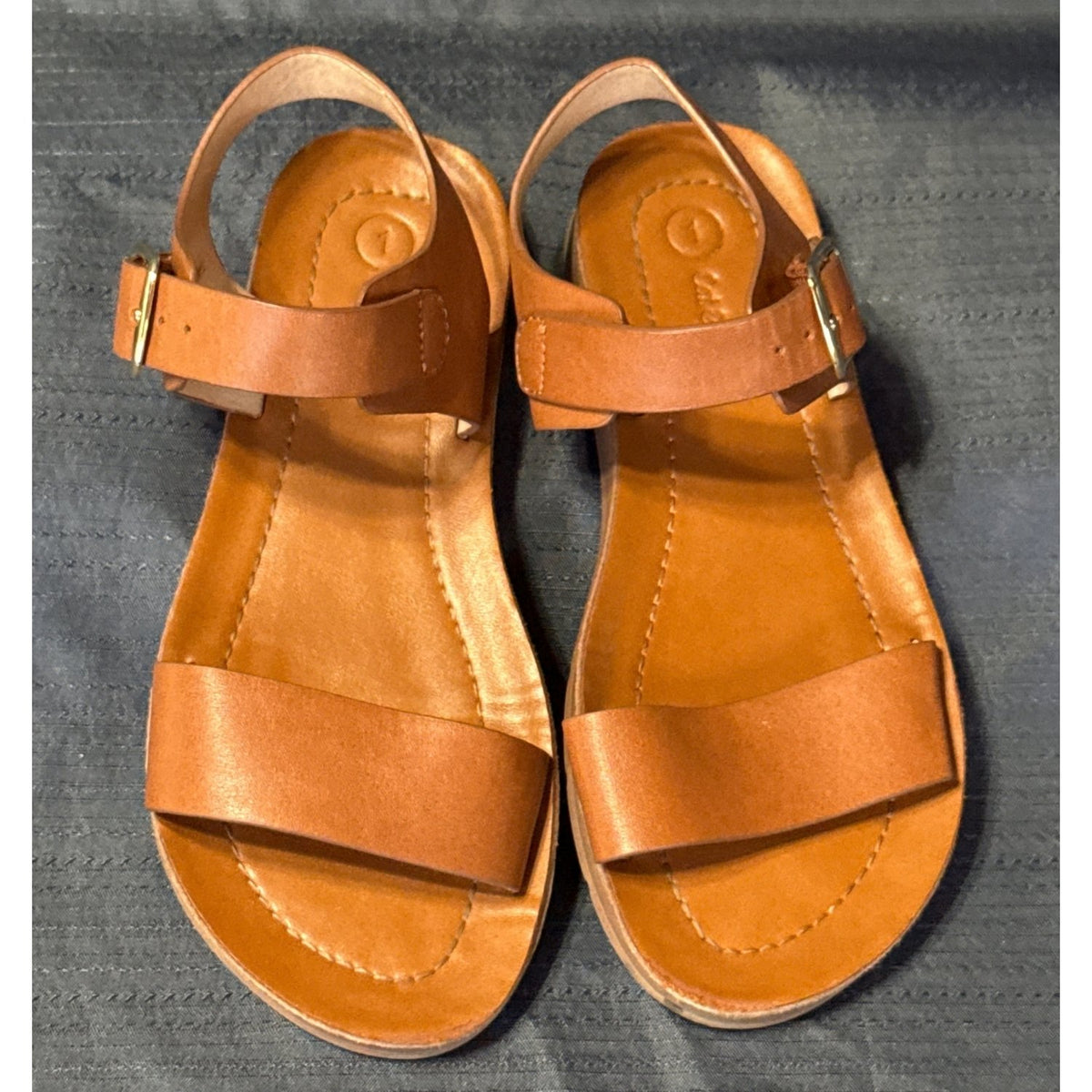 Front view of Cat & Jack girls’ size 1 tan-brown sandals with wide front straps and ankle buckles.
