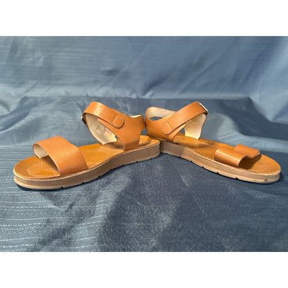 Inner side view of Cat & Jack tan-brown sandals showing the straps and flat soles.