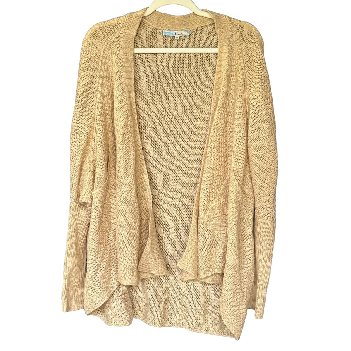 Front of a beige Cecico cardigan with a draped open front, roomy dolman sleeves, and long ribbed cuffs.