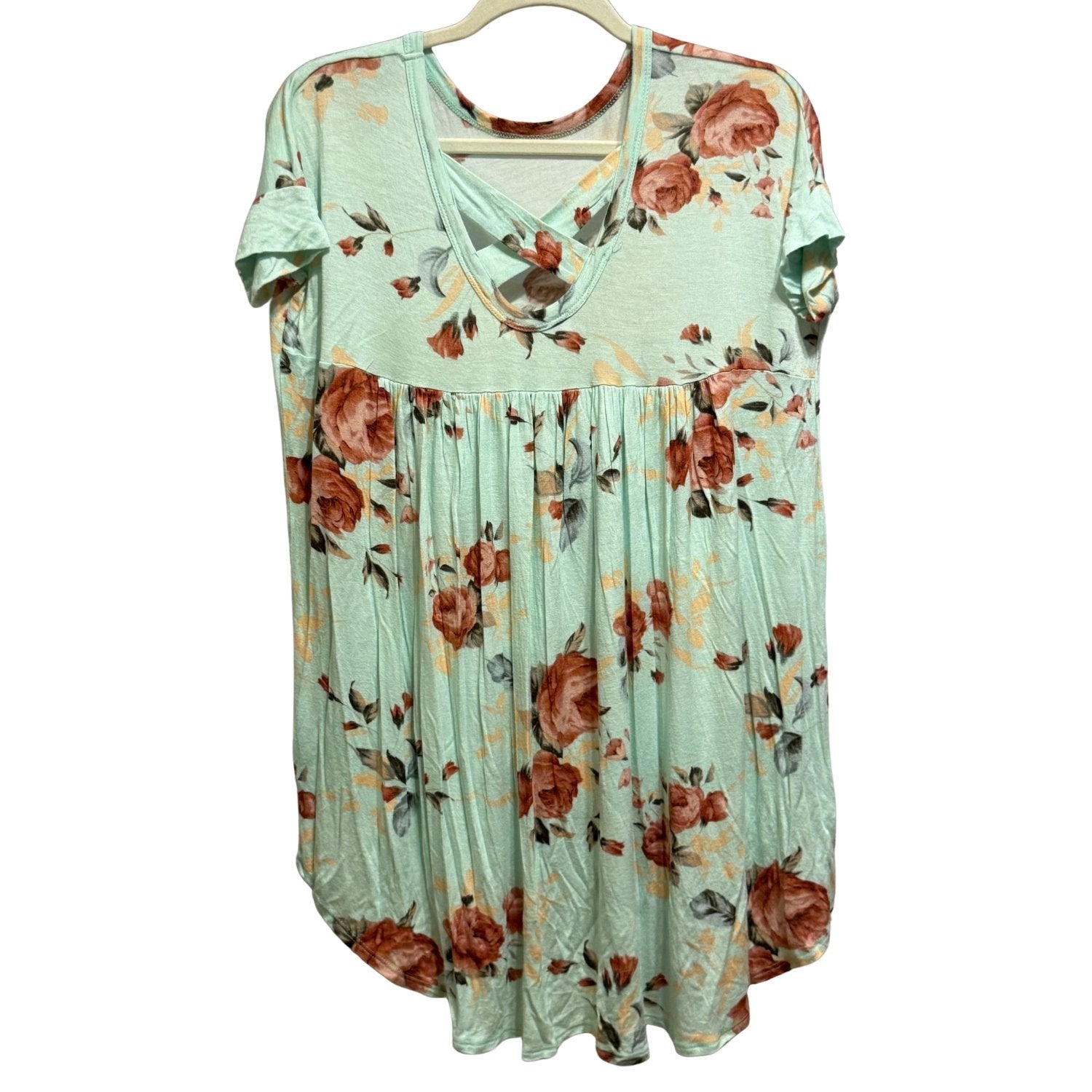 Back of COCO & MAIN mint floral tunic featuring crisscross back detail and high-low hem.