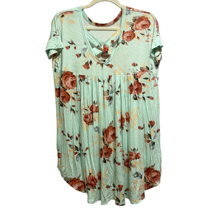 Back of COCO & MAIN mint floral tunic featuring crisscross back detail and high-low hem.