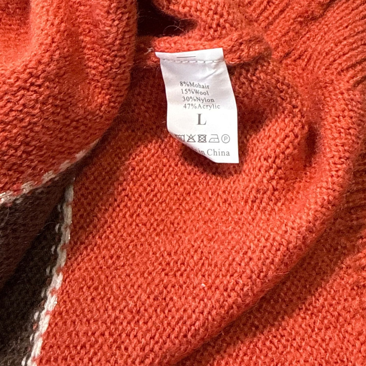 Material and size tag on women’s Large mohair and wool blend cardigan