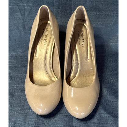 Front view of Comfort Plus by Predictions beige pumps showing rounded toes, glossy uppers, and worn insoles.