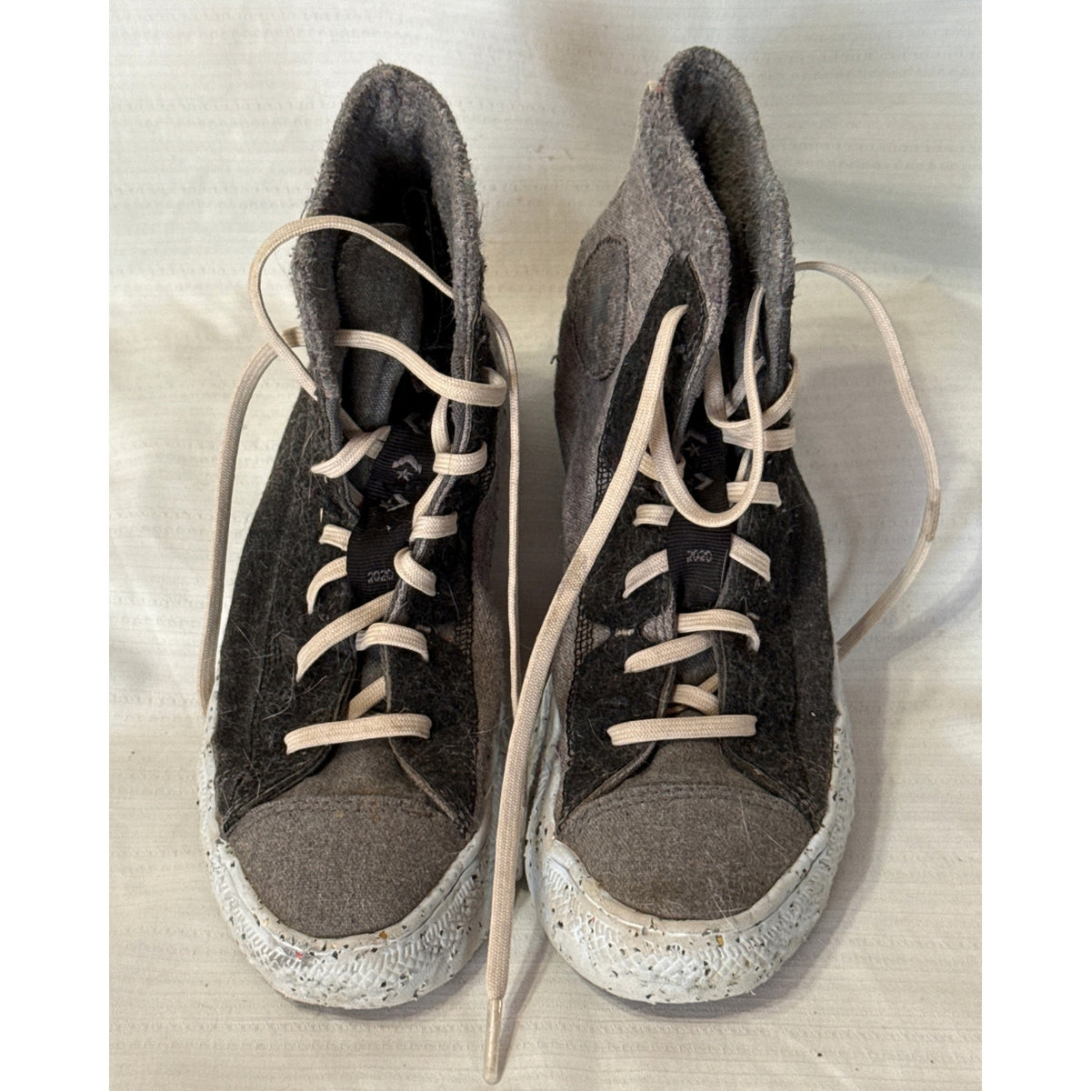 Front view of Converse Chuck Taylor All Star Crater high-top sneakers showing gray toe panels, black textured uppers, and ecru laces.