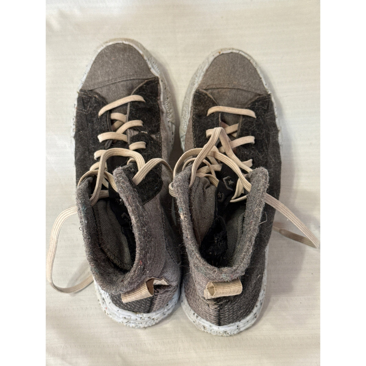 Top view of gray and black Converse Crater high-top sneakers showing ecru laces, textured fabric, and padded collars.