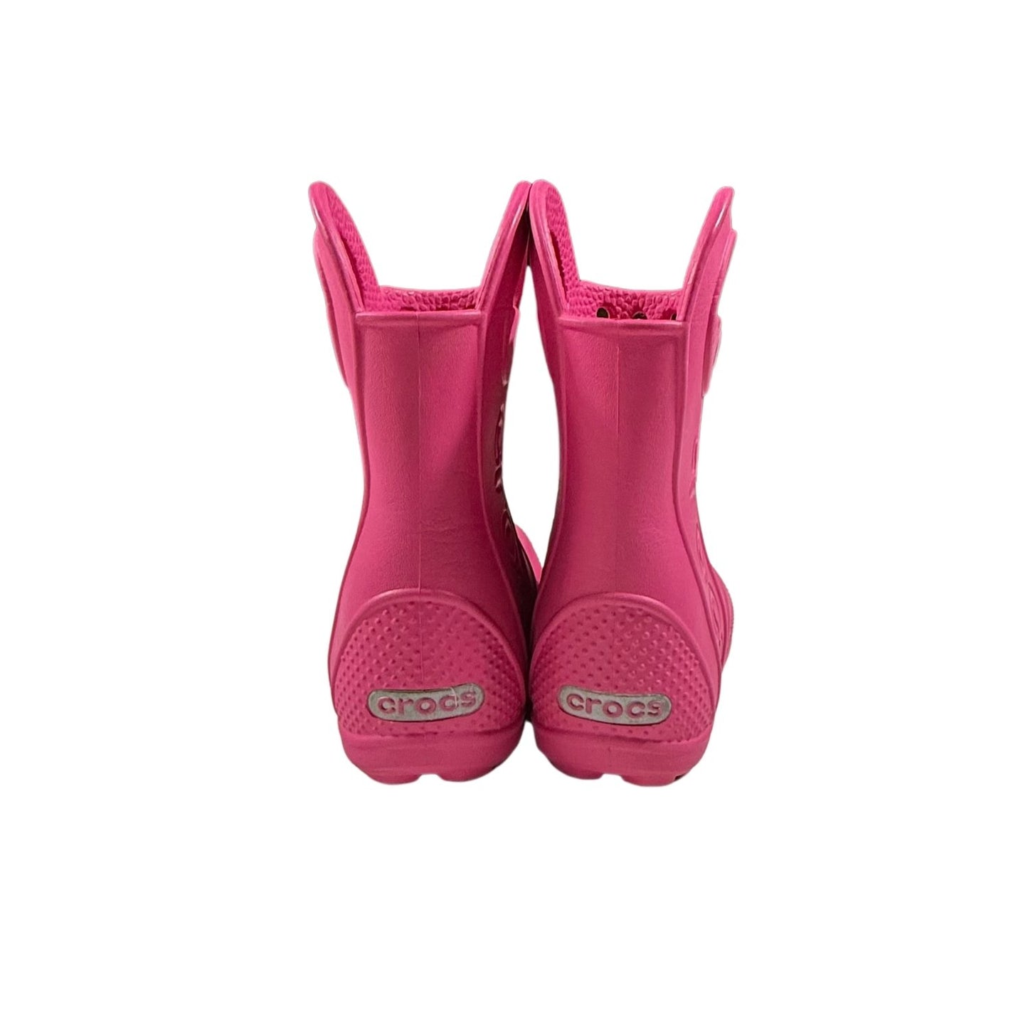 Back view of pink Crocs toddler rain boots with pull handles.