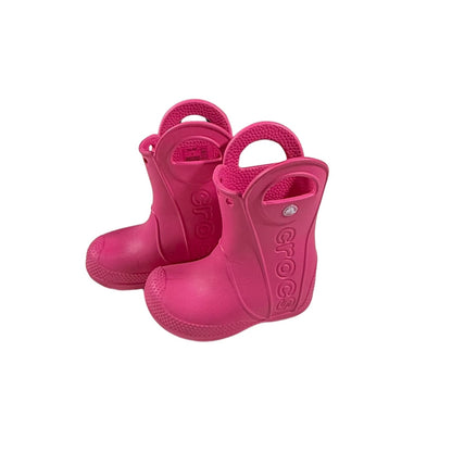 Side view of pink Crocs waterproof rain boots for toddlers.