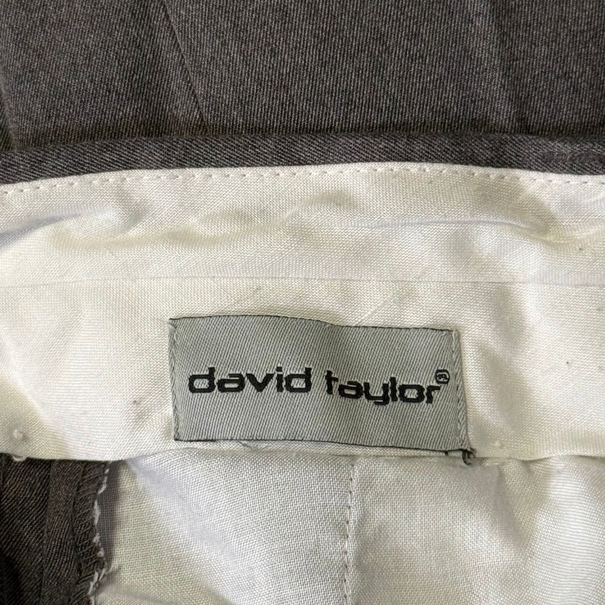 David Taylor brand label inside men's gray dress pants.