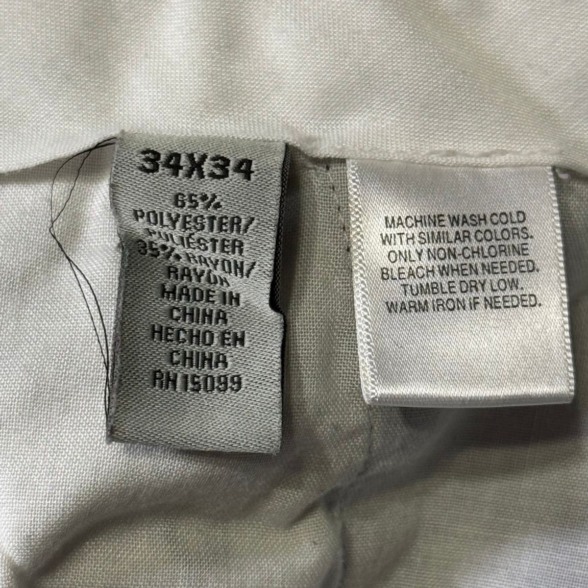 David Taylor men's dress pants size 34x34 fabric label showing 65% polyester and 35% rayon.