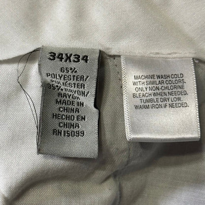 David Taylor men's dress pants size 34x34 fabric label showing 65% polyester and 35% rayon.