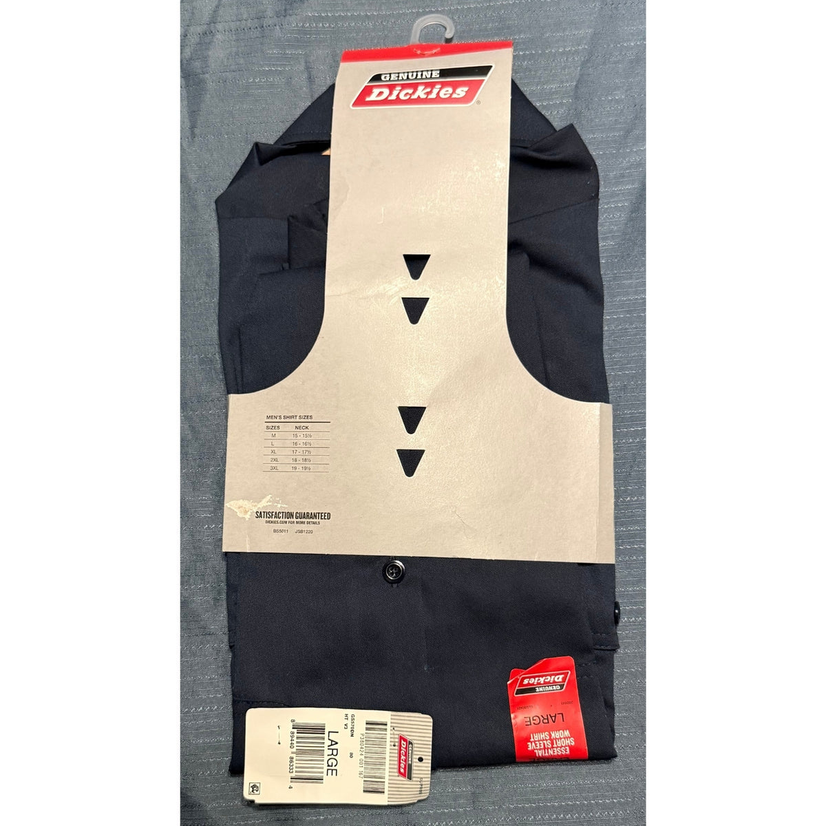 New Genuine Dickies men's large navy short sleeve work shirt folded in original retail packaging with size chart and hangtags.