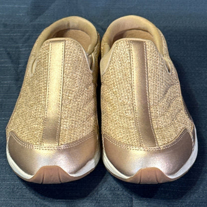 Front view of rose-gold Easy Spirit mule sneakers showing rounded toes and sparkly fabric uppers.