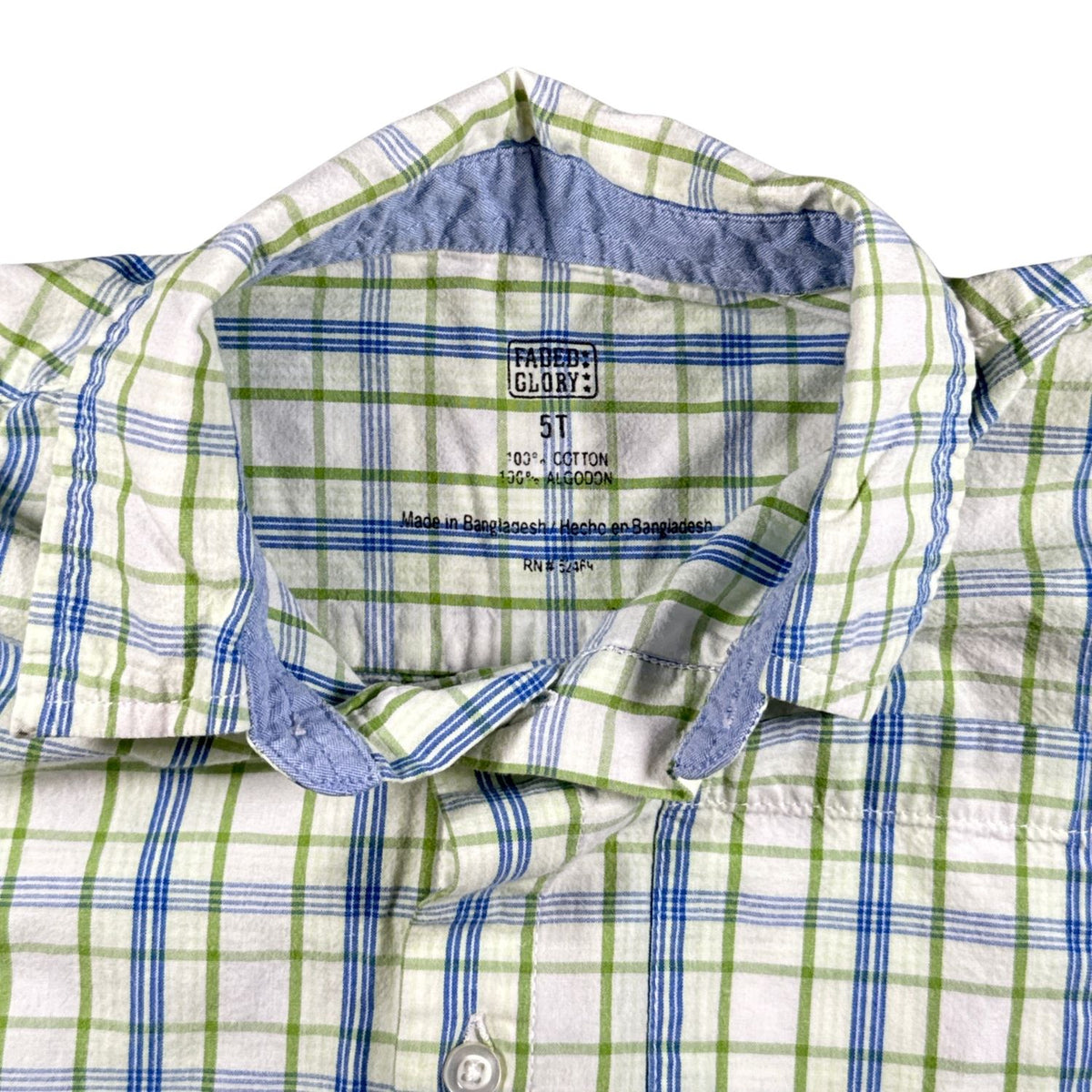 Close-up of Faded Glory boys size 5T and 100% cotton printed shirt label.