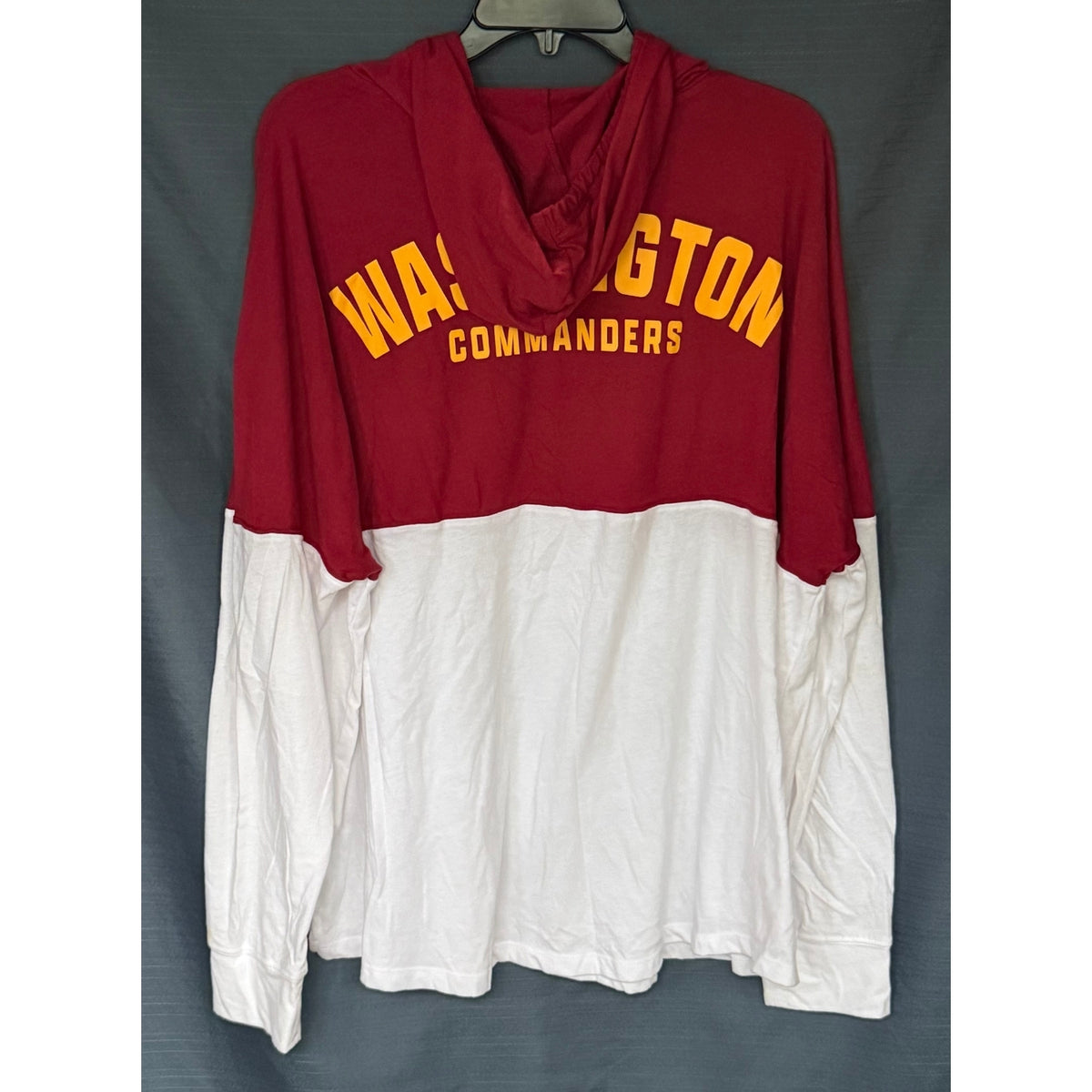 Back view of Fanatics men's 2XL Washington Commanders hooded shirt with burgundy and white color-block design and gold team lettering.