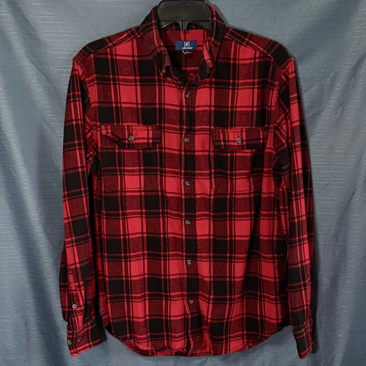 Front view of George men's medium red and black plaid cotton flannel shirt with button-down collar and two button-flap chest pockets.