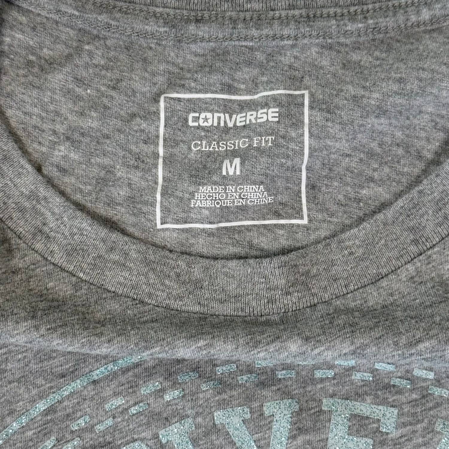 Turquoise glitter Converse logo close up on gray shirt