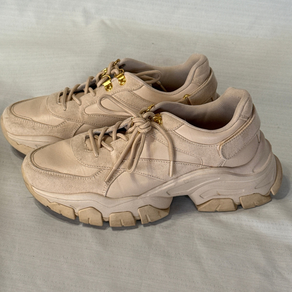 Opposite side view of JustFab Ximena blush beige sneakers showing lace-up fronts, layered panels, and chunky lug soles.