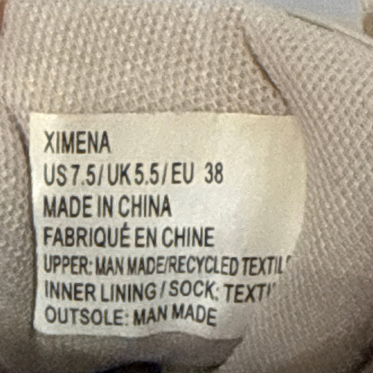 JustFab Ximena sneaker size and material label showing women's US 7.5, EU 38, and recycled textile upper.