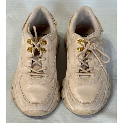 Front view of JustFab Ximena beige chunky sneakers showing rounded toes, textured panels, beige laces, and gold-tone lace hooks.