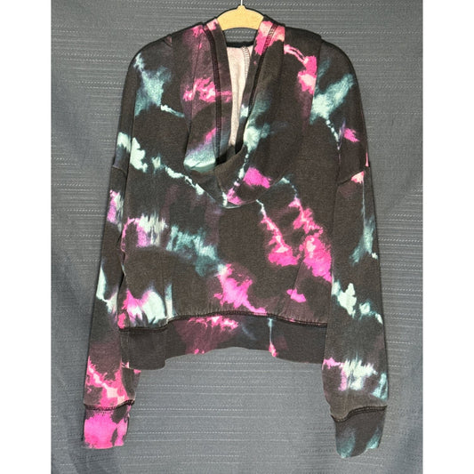 Back view of Justice girls' cropped hoodie in black, pink, and blue tie-dye with attached hood and ribbed hem.