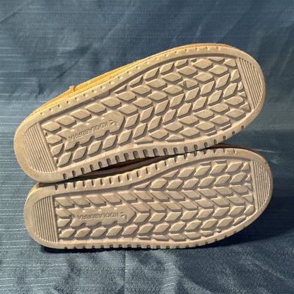 Bottom view of both Koolaburra by UGG boots showing remaining tread and light wear.