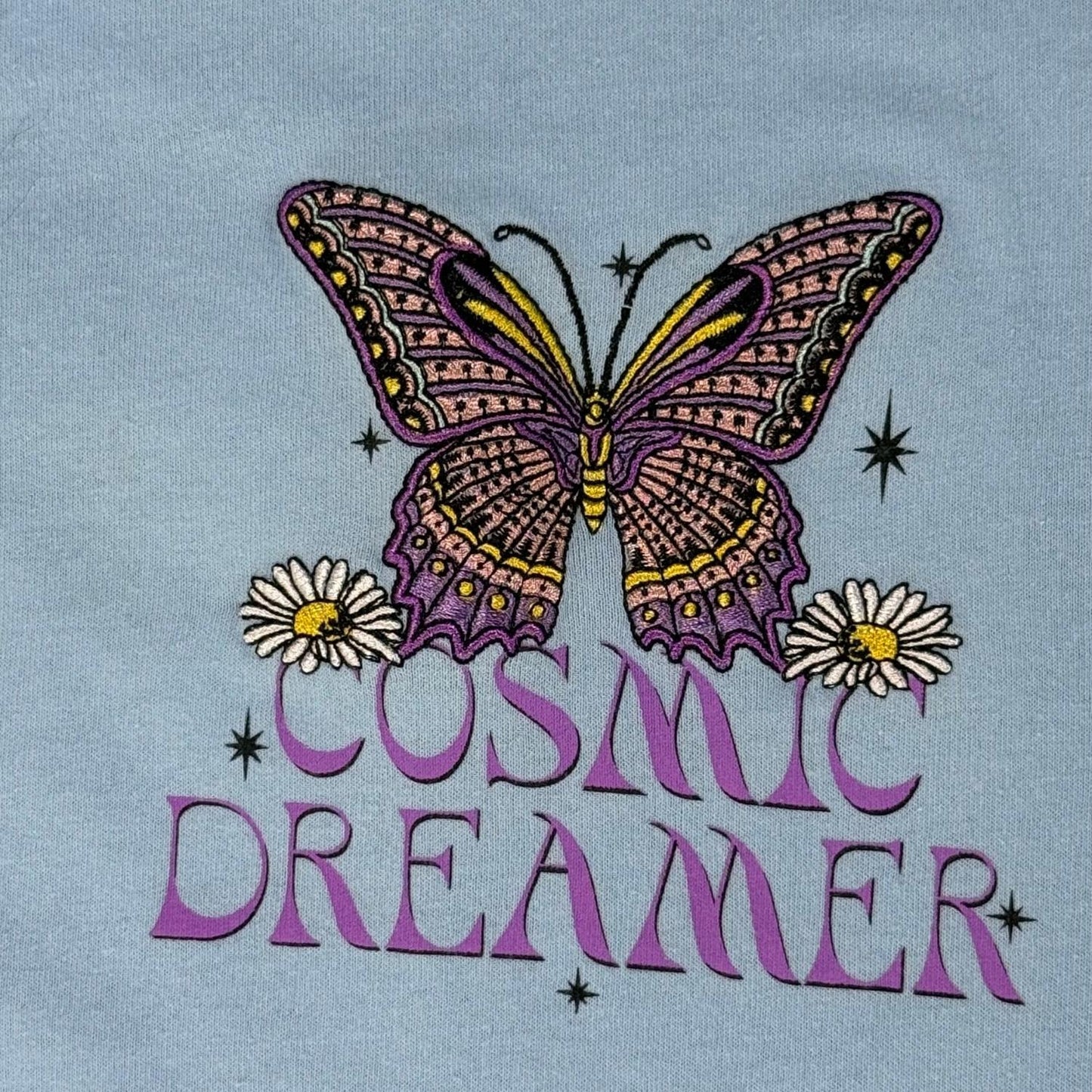 Embroidered butterfly and floral detail on Cosmic Dreamer shirt