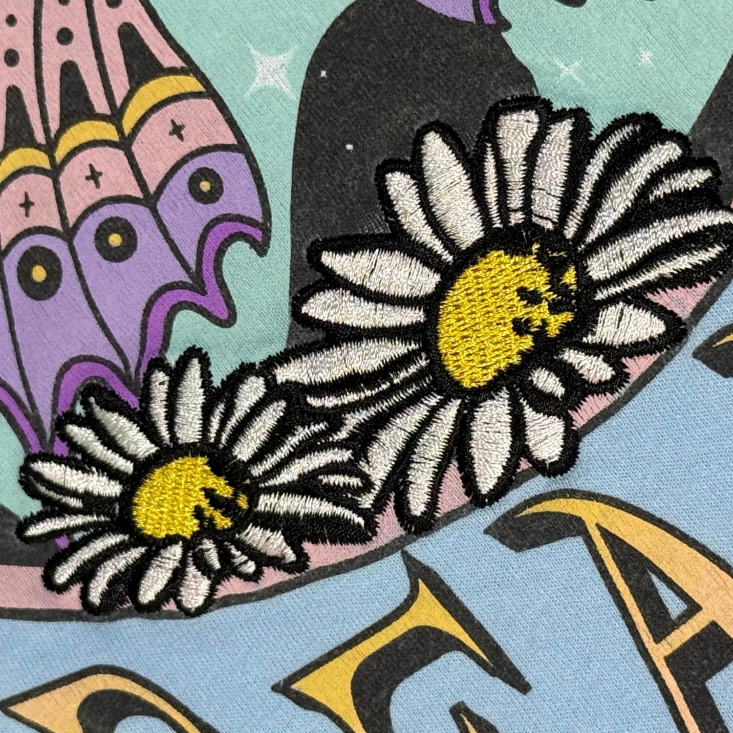 Embroidered floral detail on Cosmic Dreamer shirt