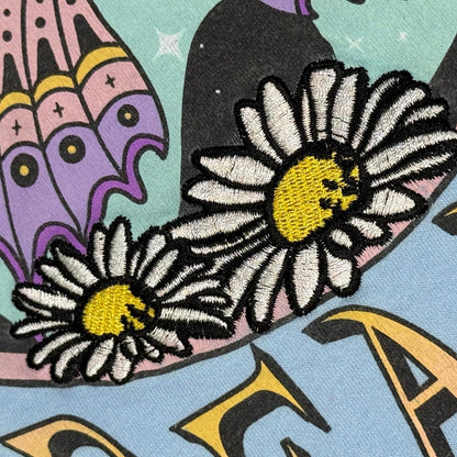 Embroidered floral detail on Cosmic Dreamer shirt