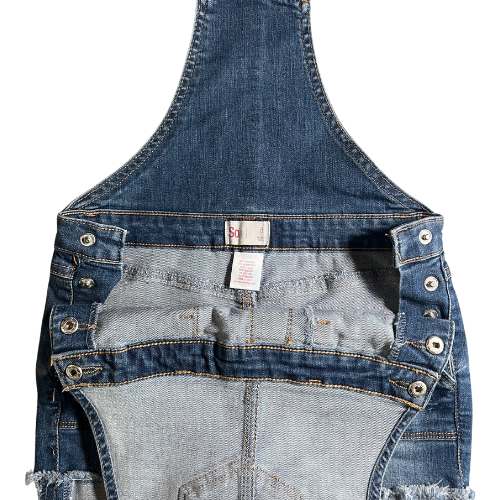 Side snaps of Gently used blue jean overalls for big girls size 8, by So, featuring snap sides, 5 pockets, rolled-up legs, and belt loops. Made from 68% cotton, 24% recycled polyester, 7% rayon, and 1% spandex. Our Families Attic