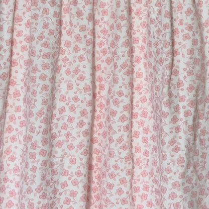 Close-up of delicate pink floral print on Little Me baby girls footed sleeper.