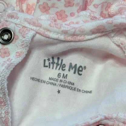 Little Me brand label showing size 6 months inside a pink floral baby footed sleeper.