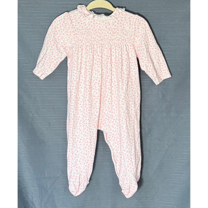 Front view of Little Me baby girls pink floral footed sleeper, size 6 months, featuring smocked chest and ruffled neckline.