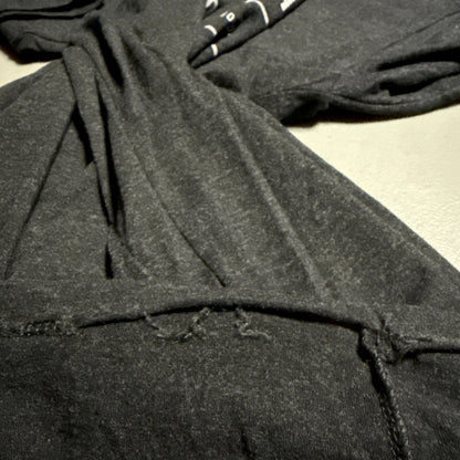 Close-up of loose stitching at one section of the T-shirt’s bottom hem.