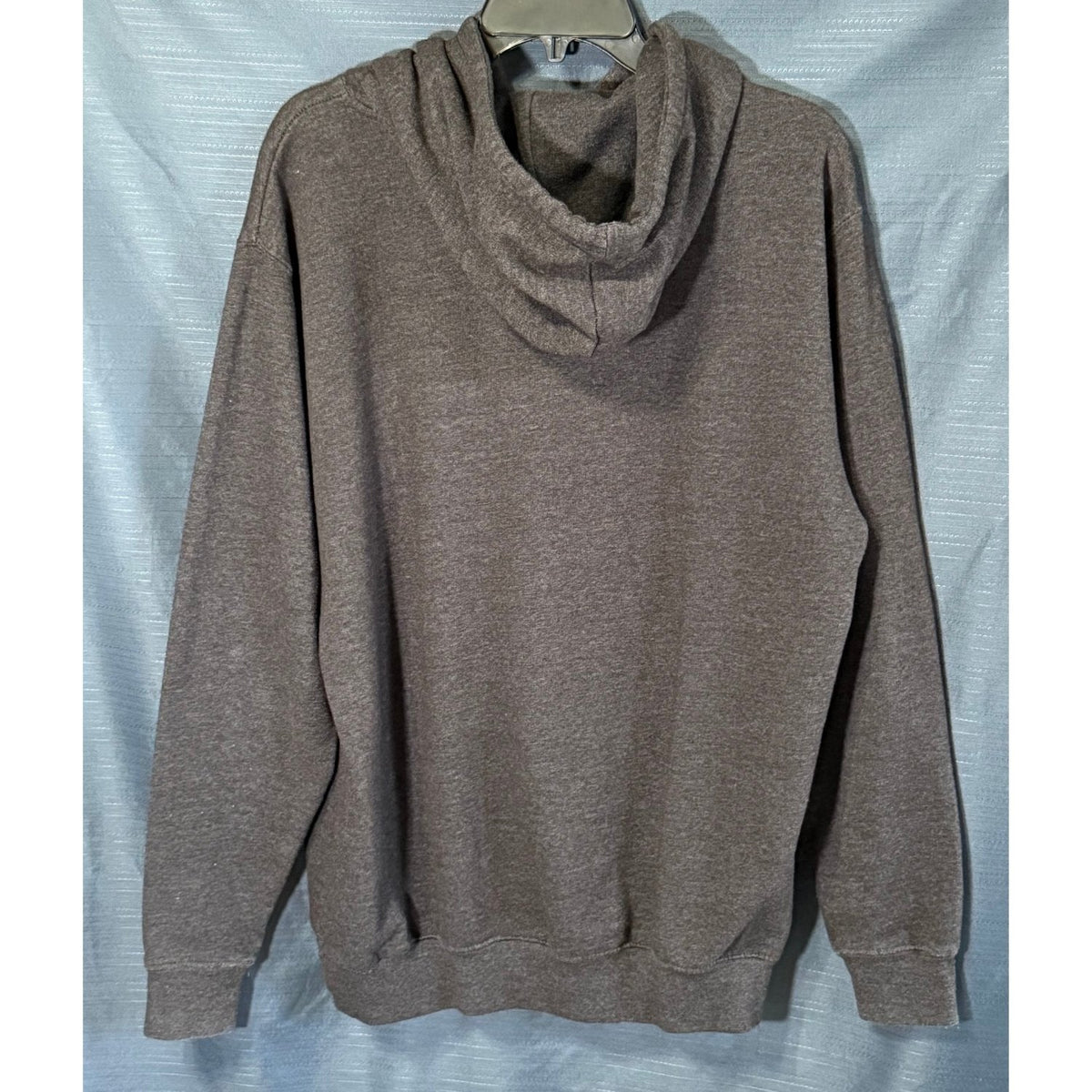 Back view of Majestic men's large charcoal gray New Orleans Saints pullover hoodie with attached hood, long sleeves and ribbed hem.