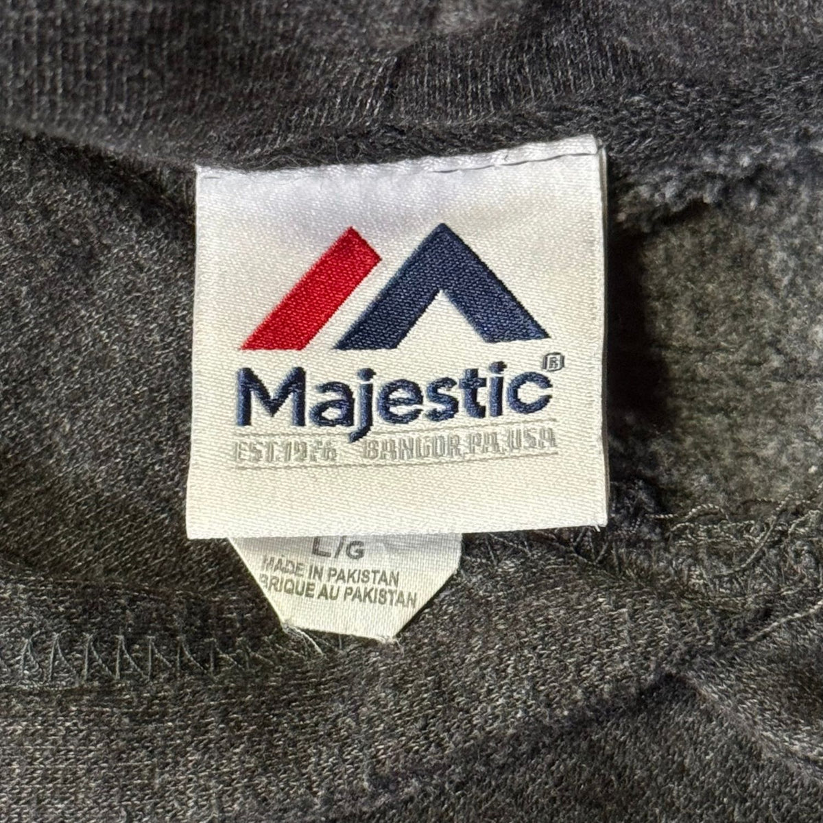 Majestic size large brand label inside charcoal gray New Orleans Saints football hoodie.