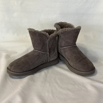 Angled front view of Member's Mark gray suede short boots showing rounded toes, exposed seams, and fluffy sheepskin lining.