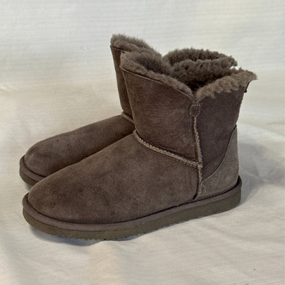 Opposite side view of Member's Mark gray suede sheepskin boots showing short shafts, rounded toes, and visible surface wear.