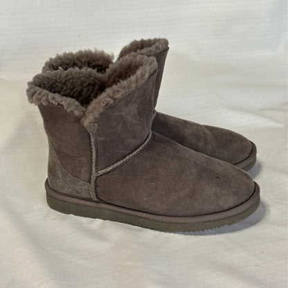 Side view of Member's Mark gray short boots showing suede uppers, stitched seams, and fuzzy sheepskin cuffs.