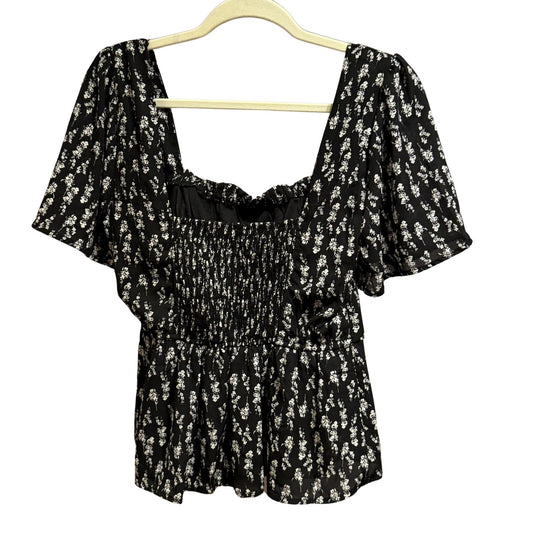 Back view of Mi Ami black floral peplum blouse with square neckline.