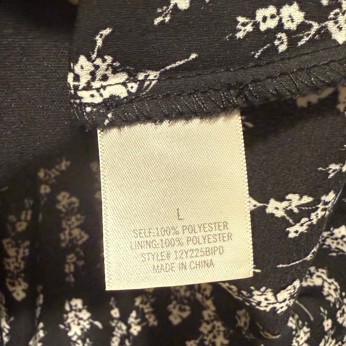 Material tag showing 100% polyester shell and lining.