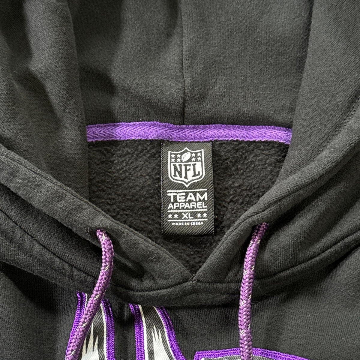NFL Team Apparel women’s XL brand label and purple drawstrings inside the black Vikings hoodie