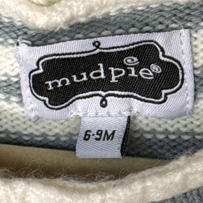 Mud Pie baby clothing label showing size 6–9 months on striped knit fabric.