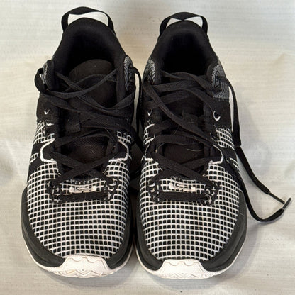Front view of black and white Nike LeBron Witness 7 sneakers showing grid-patterned toes and black laces.
