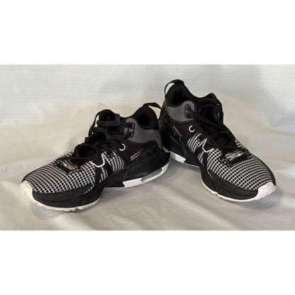 Pair of Nike LeBron Witness 7 black and white lace-up basketball shoes shown at an angle.