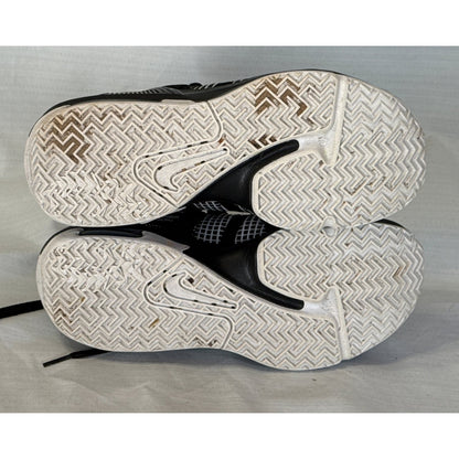 White rubber outsoles of Nike LeBron Witness 7 basketball shoes showing tread pattern and wear.