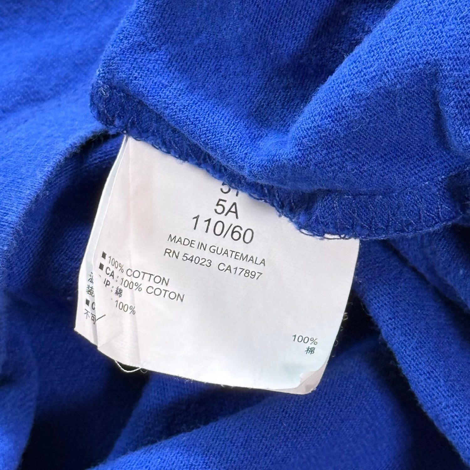 Old Navy size 5T shirt care tag showing 100 percent cotton